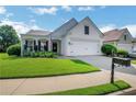 Charming single-story home with manicured lawn and attached two-car garage on a sunny day at 4140 Prince Charles Dr, Duluth, GA 30097