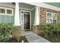 Close up of a front door with stone accents and light green siding at , Conyers, GA 30012