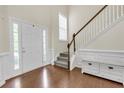 Inviting foyer featuring hardwood floors, staircase, and a large front door with sidelights at 213 Roseman Way, Woodstock, GA 30188