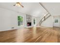 Spacious living room with hardwood floors, fireplace, and staircase to the second floor at 3617 Lassiter Rd, Marietta, GA 30062