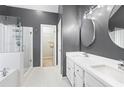 Stylish bathroom with a glass-enclosed shower, double sink vanity, and modern fixtures, enhanced by hexagonal floor tiles at 3793 Market Cres, Clarkston, GA 30021