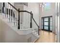 Welcoming two-story entryway with hardwood floors, a staircase with black banister, and modern front door with glass panels at 3793 Market Cres, Clarkston, GA 30021