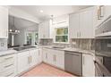 Modern kitchen features white cabinetry, stainless steel appliances, and granite countertops with a bright window at 3793 Market Cres, Clarkston, GA 30021