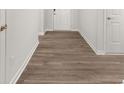Hallway featuring attractive hardwood flooring, creating a cohesive and stylish look at 917 Sundown Pt, Villa Rica, GA 30180