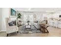 Open concept living room boasts an electric fireplace, hardwood floors, and neutral tones at 2018 Wyndham Pl, Conyers, GA 30013