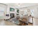 Well-lit living room featuring hardwood floors, neutral tones, fireplace, and comfortable seating at 2018 Wyndham Pl, Conyers, GA 30013