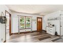 Bright, open living room featuring wood-look flooring, a large window, and tasteful decor for a welcoming atmosphere at 202 Cedar Valley Ct, Canton, GA 30115