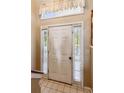 Bright foyer featuring tile flooring and sidelights surrounding the front door at 60 Boardwalk Ave, Covington, GA 30016