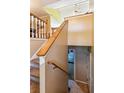 Carpeted staircase with wooden railings leading to the upper level of the home at 60 Boardwalk Ave, Covington, GA 30016