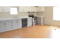 Functional kitchen with wood floors, matching gray cabinets, and modern appliances in a well lit space at 901 N Van Wert N Rd, Villa Rica, GA 30180