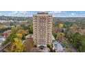 High-rise condo building with a pool and lush trees in the background at 1501 Clairmont Rd # 1731, Decatur, GA 30033