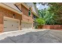 Spacious three-car garage with a long driveway and brick exterior at 2748 Hidden Falls Dr, Buford, GA 30519