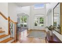 Bright foyer features hardwood floors, a staircase, and a view into the dining area at 5059 Belair Bluff Se Ct, Smyrna, GA 30126