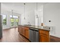 Well-lit kitchen boasts granite counters, stainless appliances, and a breakfast bar island with stylish pendant lighting at 425 Chapel Sw St # 1211, Atlanta, GA 30313
