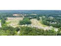 Picture-perfect aerial showcasing a community with a backdrop of lush greenery and serene landscape views at 910 Sundown Pt, Villa Rica, GA 30180