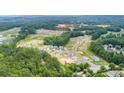 Expansive aerial view of the community showcasing new homes, winding roads, and lush greenery at 910 Sundown Pt, Villa Rica, GA 30180