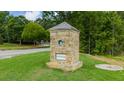 Stone monument for Northwoods community featuring lush landscaping and clear signage for the neighborhood entrance at 910 Sundown Pt, Villa Rica, GA 30180