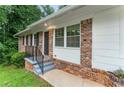 Inviting brick front porch with modern railings and a freshly painted front door at 2775 Belleau Se Ln, Atlanta, GA 30316