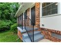 A close-up view of the welcoming front porch featuring brick accents and stylish railings at 2775 Belleau Se Ln, Atlanta, GA 30316