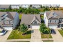 Aerial view showcasing the property with a well-maintained lawn, driveway, and neighborhood at 5318 Burrus Ln, Mableton, GA 30126