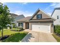 Attractive home with a two-car garage, brick facade, manicured lawn, and vibrant landscaping at 5318 Burrus Ln, Mableton, GA 30126