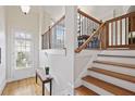 Welcoming entryway featuring hardwood floors, staircase with iron railings, and bright natural light at 1605 Pavillion Ridge Se Dr, Smyrna, GA 30080