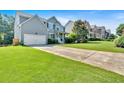 Suburban home with a wide driveway, attached garage, and classic facade design nestled in a well-kept neighborhood at 290 Prescott Dr, Acworth, GA 30101