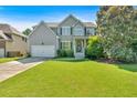Lovely two-story home with a lush green lawn, attached garage, and inviting front entrance under a sunny sky at 290 Prescott Dr, Acworth, GA 30101