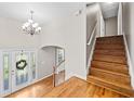 Inviting foyer with hardwood floors, staircase, and decorative chandelier creates a welcoming atmosphere at 412 Gray Fox Dr, Canton, GA 30114