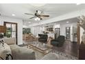 Open-concept living room featuring stylish furniture, a ceiling fan, and seamless flow into the dining and kitchen areas at 1477 Spruce Dr, Smyrna, GA 30080