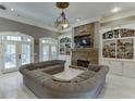 Comfortable living room features a stone fireplace, built-in shelving, and a large sectional sofa at 2871 Hosch Valley Rd, Buford, GA 30519