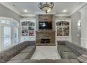 Bright living room with a stone fireplace, custom built-ins, and an oversized sectional couch at 2871 Hosch Valley Rd, Buford, GA 30519