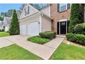 Charming home exterior featuring a well-maintained lawn and a two-car garage at 3686 Claredun Ct, Cumming, GA 30040