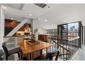 Open concept kitchen and dining area with stainless steel appliances and city skyline views at 30 5Th Ne St # 1010, Atlanta, GA 30308