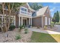 Elegant brick home with a covered entryway, white columns, and manicured landscaping creating inviting curb appeal at 3123 Wolf Club Dr. Sw, Atlanta, GA 30349
