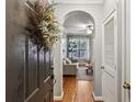 Welcoming entryway with hardwood floors, a decorative wreath, and an arched doorway to living area at 3777 Peachtree Ne Rd # 1216, Atlanta, GA 30319