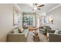 Cozy living room featuring hardwood floors, neutral paint, ceiling fan, and large window with blinds at 3777 Peachtree Ne Rd # 1216, Atlanta, GA 30319