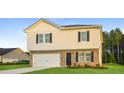 Charming two-story home featuring a brick facade, attached garage, and well-maintained lawn at 45 Chimney Ridge Ln, Covington, GA 30014