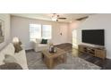 Cozy living room with a ceiling fan, neutral color scheme, comfortable seating, and a modern television at 45 Chimney Ridge Ln, Covington, GA 30014