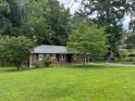 Traditional brick home featuring a well-maintained lawn, mature trees, and classic window shutters at 2014 Brannen Se Rd, Atlanta, GA 30316