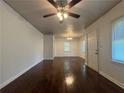 Bright living room with dark hardwood floors, white walls, and a ceiling fan for year-round comfort at 2014 Brannen Se Rd, Atlanta, GA 30316