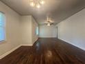 Spacious living room featuring wood floors, white walls, and lots of natural light from the windows at 2014 Brannen Se Rd, Atlanta, GA 30316