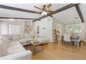 Spacious living room with hardwood floors, wooden ceiling beams, and adjacent dining area at 231 Cross Gate Dr, Marietta, GA 30068