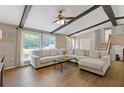 Inviting living room with hardwood floors, ceiling beams, and ample natural light at 231 Cross Gate Dr, Marietta, GA 30068