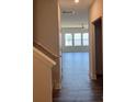 Inviting hallway showcasing hardwood floors leading to the living area with ample natural light at 3536 Dogwood Pass, Lithonia, GA 30038
