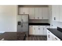 Well-lit kitchen with stainless steel refrigerator, granite countertops, and ample cabinet space at 3536 Dogwood Pass, Lithonia, GA 30038
