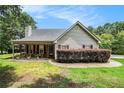 Charming home featuring a covered front porch and stone accents enhancing its curb appeal at 55 Ashland Farm Rd, Oxford, GA 30054