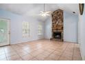Spacious living room featuring a stone fireplace, and tile flooring creating a cozy atmosphere at 55 Ashland Farm Rd, Oxford, GA 30054