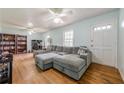 Inviting living room with hardwood floors, a large sectional couch, and plenty of natural light at 5709 Center Hill Church Rd, Loganville, GA 30052