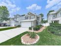Traditional two-story house with a two-car garage, tidy lawn, and landscape features at 232 Oconee Way, Canton, GA 30114